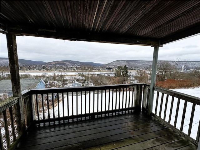 snow covered deck featuring a mountain view