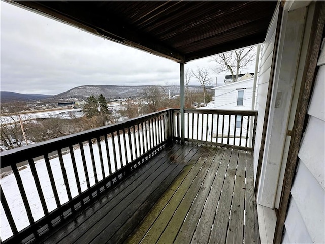 snow covered deck featuring a mountain view