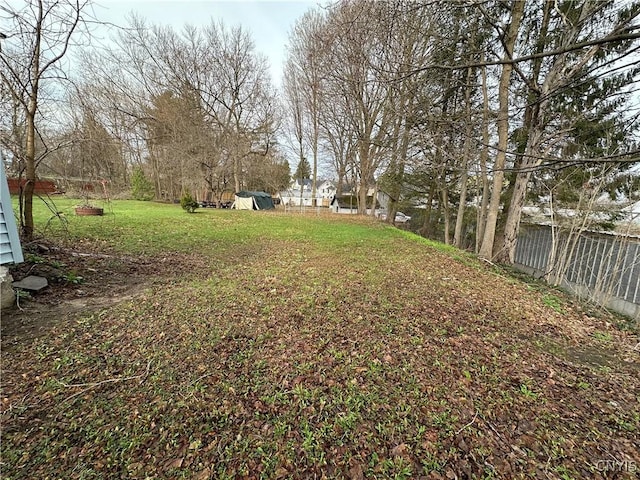view of yard featuring a shed and fence