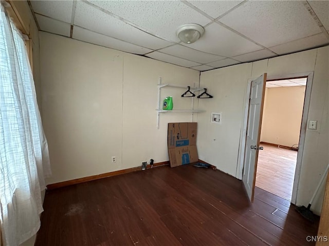 clothes washing area featuring washer hookup, wood finished floors, laundry area, and baseboards