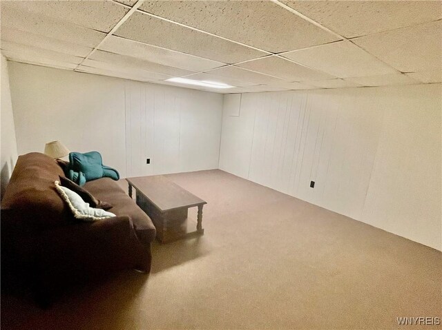 sitting room with a drop ceiling and carpet floors