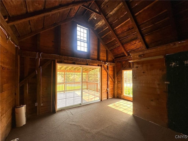 interior space with wood ceiling, wooden walls, high vaulted ceiling, and carpet flooring