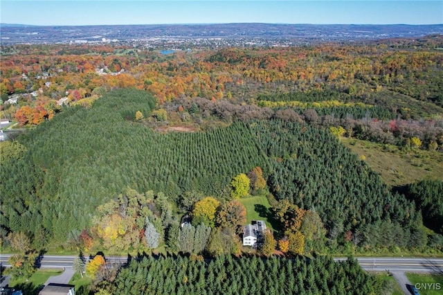 drone / aerial view featuring a wooded view