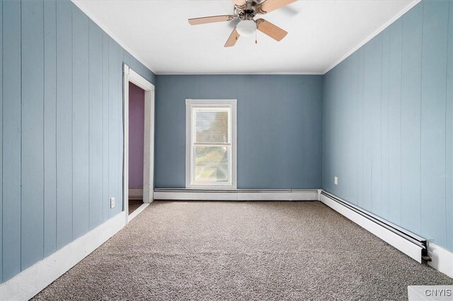 52 Front St, Norwich-City, NY 13815 - carpeted spare room with wood walls, ceiling fan, ornamental molding, and a baseboard heating unit
