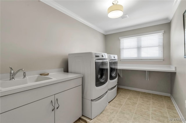 laundry area with a sink, cabinet space, separate washer and dryer, visible vents, and ornamental molding
