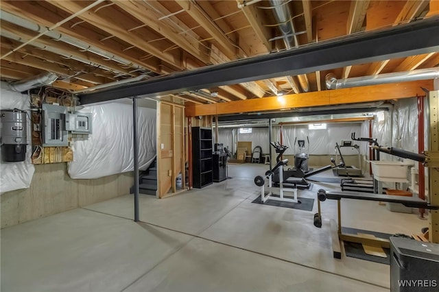 unfinished basement featuring stairs and electric panel
