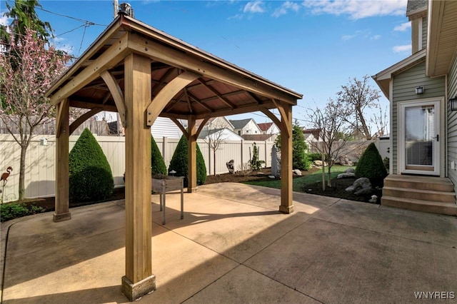 view of patio / terrace featuring a gazebo, entry steps, and a fenced backyard