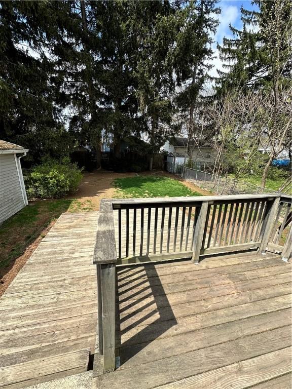 deck with a lawn and fence