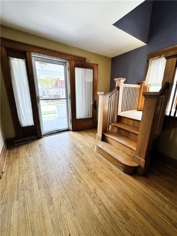 doorway to outside featuring stairway, visible vents, and light wood finished floors