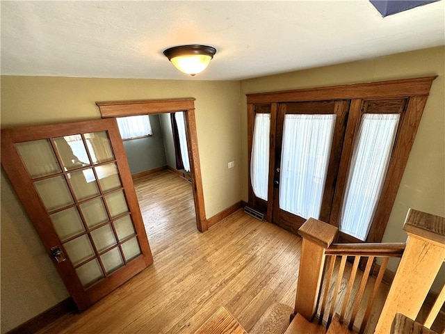 entrance foyer featuring light wood-style flooring and baseboards