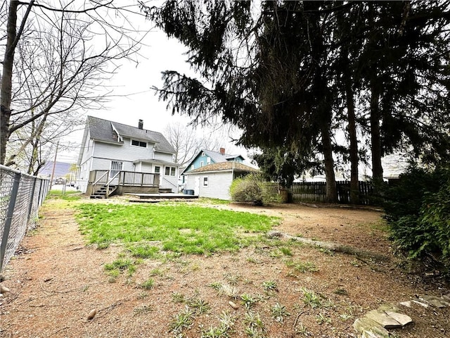 view of yard with a wooden deck and a fenced backyard