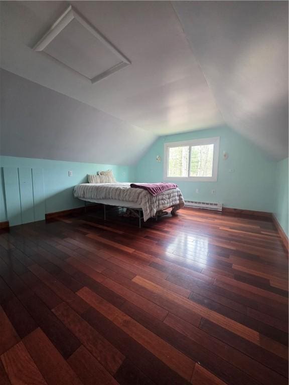 bedroom featuring attic access, vaulted ceiling, baseboards, hardwood / wood-style flooring, and a baseboard radiator