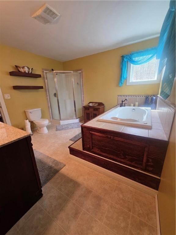 bathroom with a shower stall, vanity, a bath, toilet, and visible vents