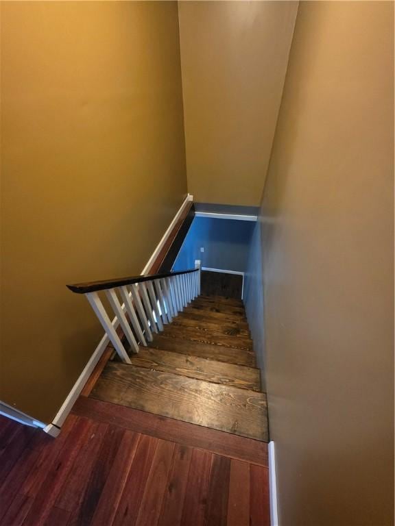 stairs with baseboards and wood finished floors