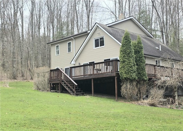rear view of property with stairs, a wooden deck, a chimney, a shingled roof, and a yard