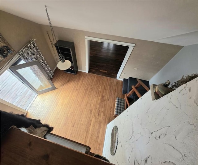 interior space with wood finished floors and baseboards