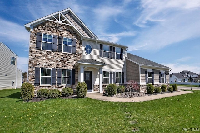 view of front of house featuring a front lawn and stone siding
