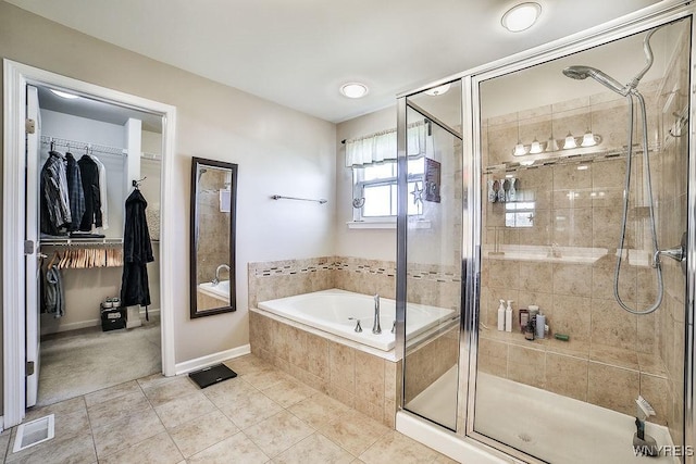 bathroom with visible vents, a garden tub, tile patterned floors, a spacious closet, and a stall shower
