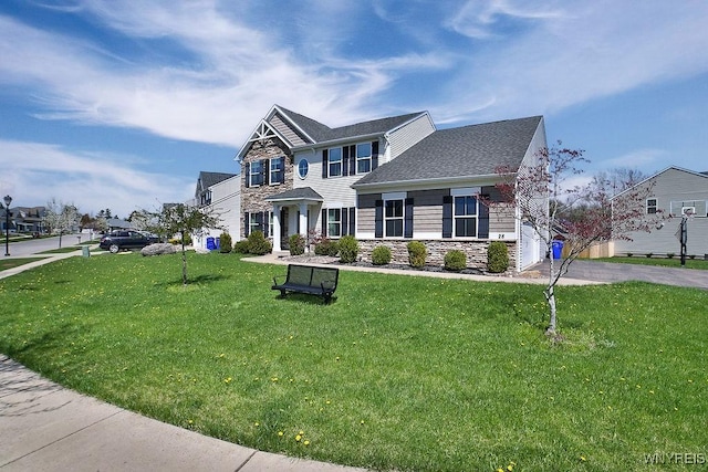 view of front facade featuring roof with shingles, a front lawn, and stone siding