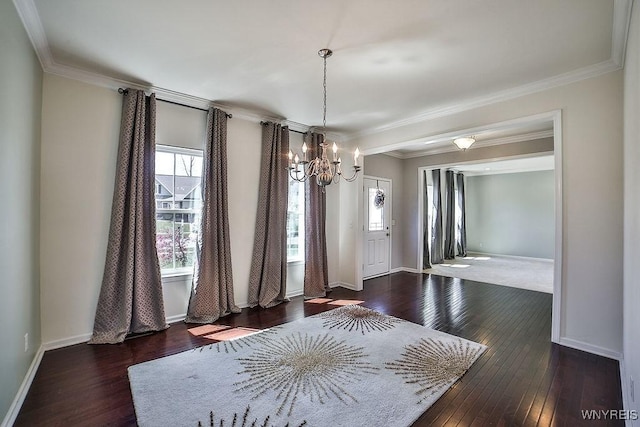 interior space featuring ornamental molding, a notable chandelier, and hardwood / wood-style flooring