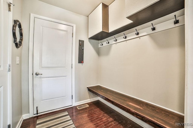 mudroom featuring visible vents, dark wood-style flooring, and baseboards