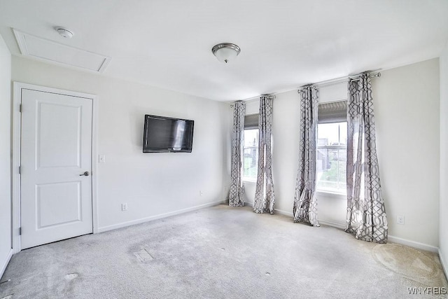 carpeted spare room with baseboards