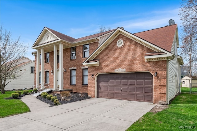 greek revival inspired property featuring concrete driveway, brick siding, and an attached garage