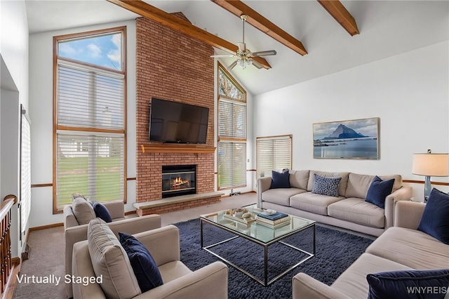 living room with carpet flooring, beamed ceiling, a fireplace, a ceiling fan, and high vaulted ceiling