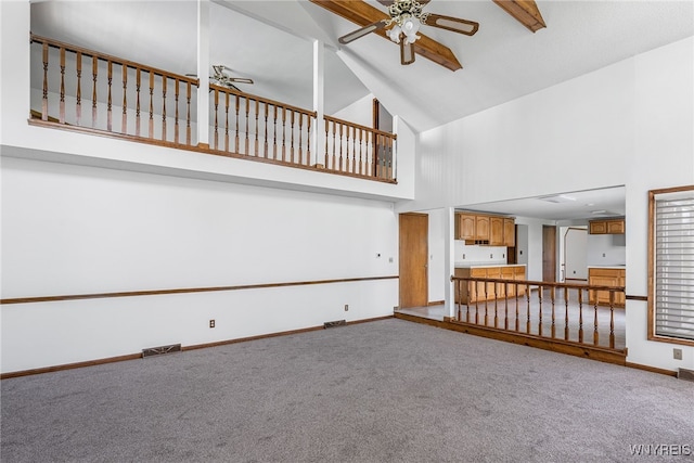 unfurnished living room featuring visible vents, high vaulted ceiling, ceiling fan, and carpet