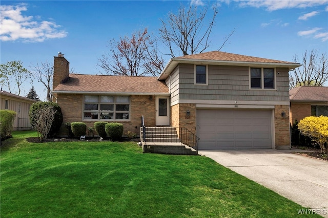 tri-level home featuring a chimney, brick siding, a garage, driveway, and a front yard