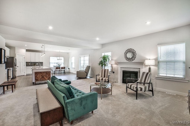 living area featuring visible vents, a high end fireplace, baseboards, recessed lighting, and carpet