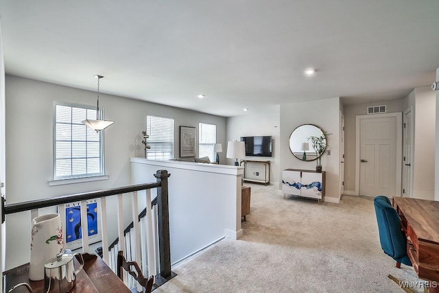 interior space featuring recessed lighting, carpet floors, an upstairs landing, baseboards, and visible vents