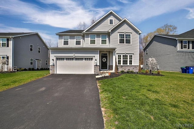 craftsman-style home featuring a garage, aphalt driveway, a front yard, and stone siding