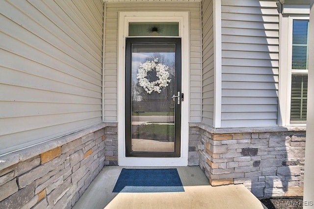 view of exterior entry with stone siding