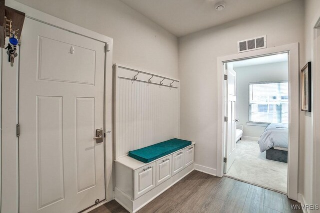 mudroom with visible vents, dark wood finished floors, and baseboards
