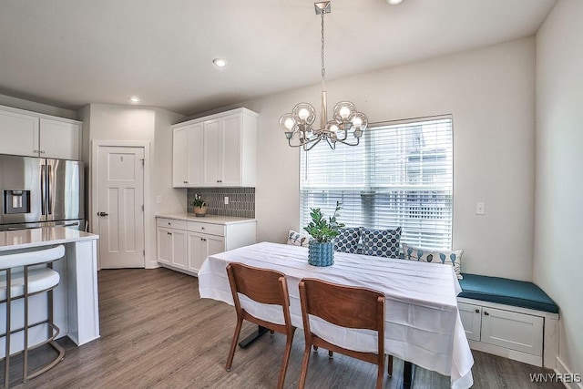 dining area featuring an inviting chandelier, recessed lighting, and dark wood-style floors