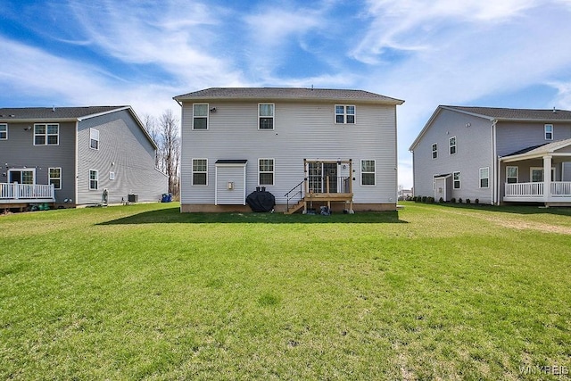 rear view of house featuring a yard