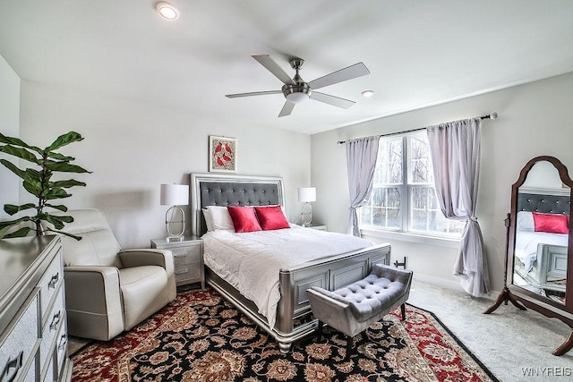 carpeted bedroom featuring a ceiling fan and baseboards
