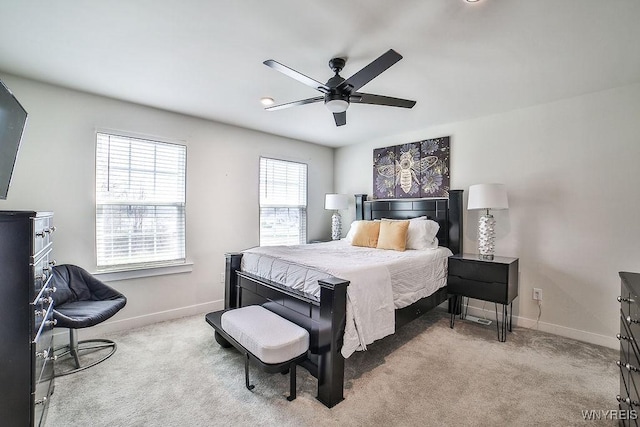 carpeted bedroom featuring ceiling fan and baseboards