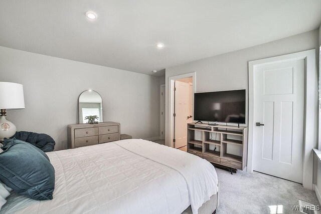 bedroom featuring recessed lighting and light carpet