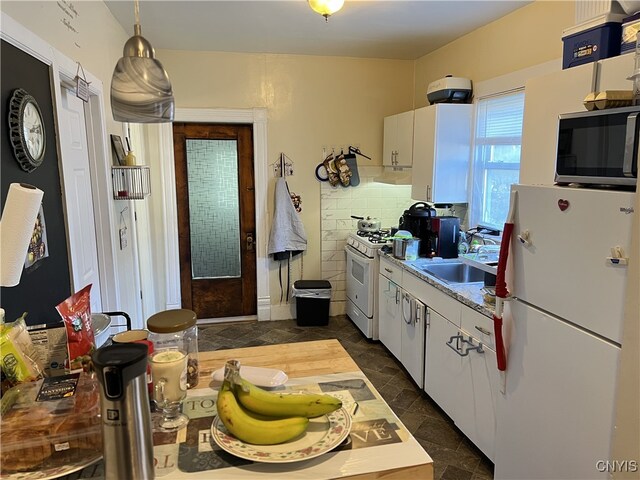 210 Duane St, Syracuse, NY 13207 - kitchen featuring white appliances, light countertops, stone finish flooring, a sink, and white cabinetry