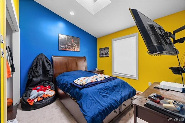 carpeted bedroom featuring recessed lighting and vaulted ceiling with skylight