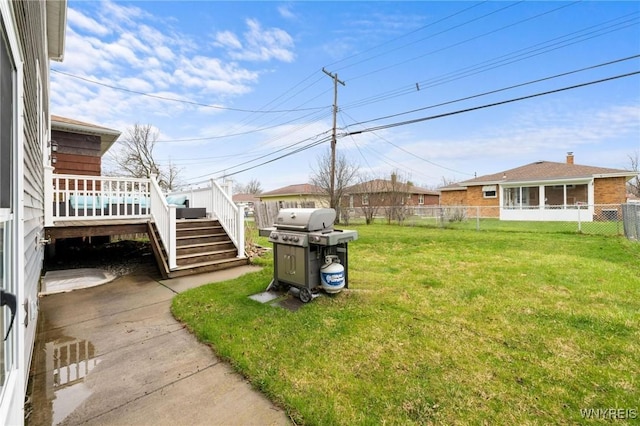 view of yard with a deck, stairway, and a fenced backyard