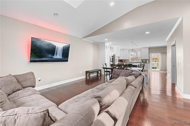 living area with dark wood-style floors, baseboards, lofted ceiling, and crown molding