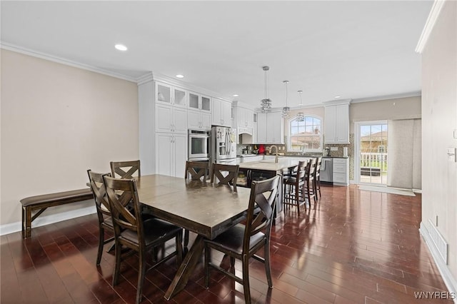 dining space featuring crown molding, recessed lighting, dark wood-style flooring, and baseboards
