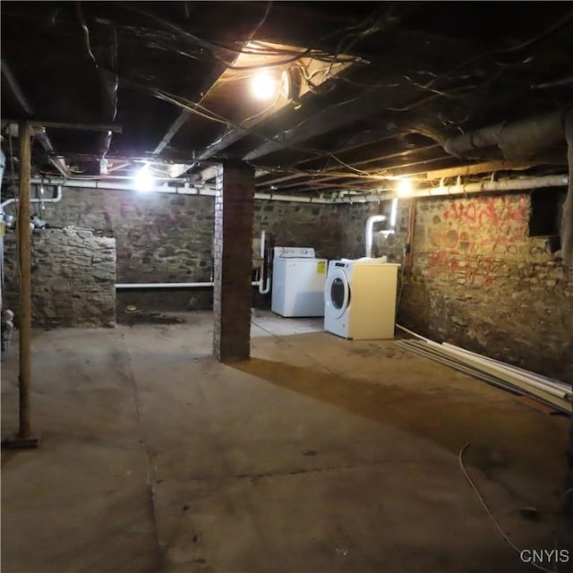 unfinished below grade area featuring separate washer and dryer
