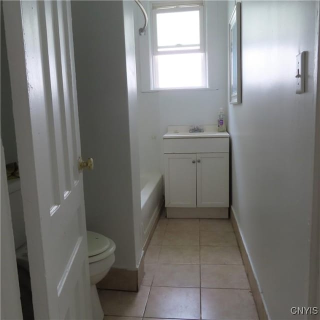 bathroom with shower / tub combination, vanity, tile patterned floors, toilet, and baseboards