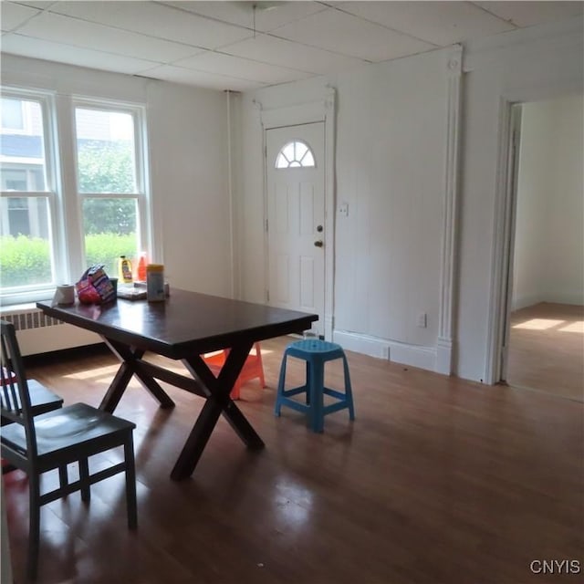 dining area featuring radiator, wood finished floors, and baseboards
