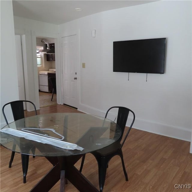 dining area featuring wood finished floors and baseboards