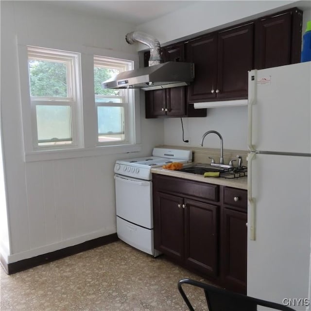 kitchen with a sink, light countertops, baseboards, exhaust hood, and white appliances